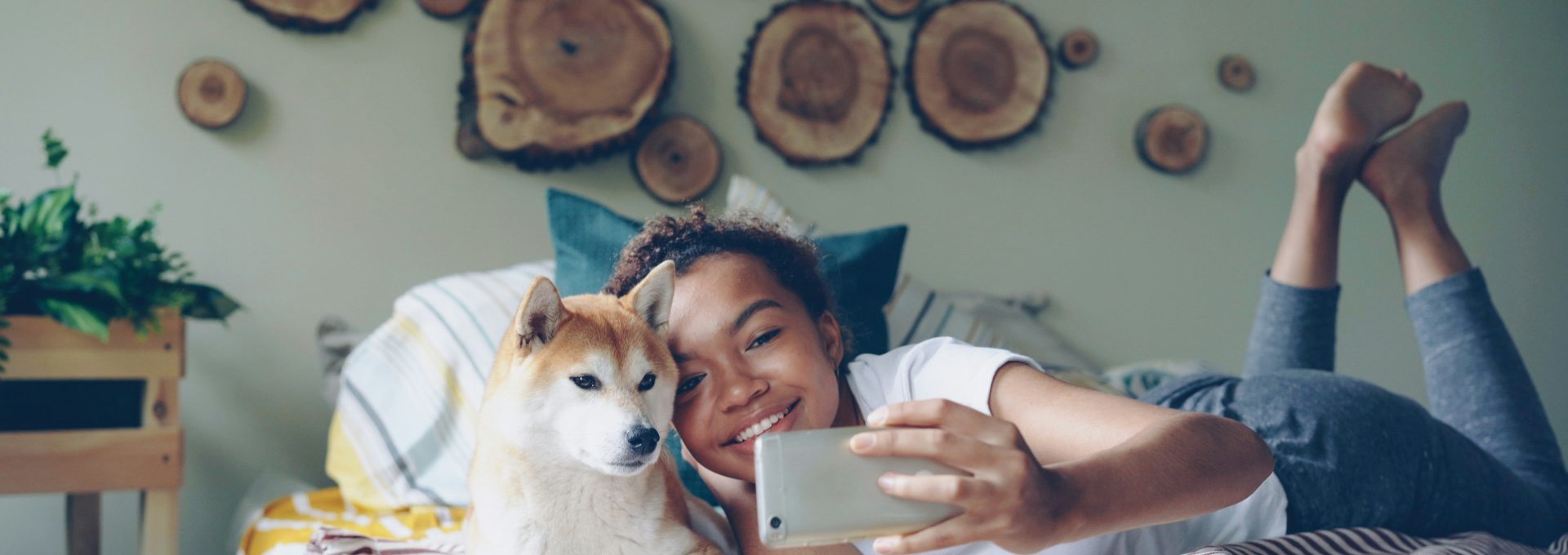Woman and dog take a selfie in bed